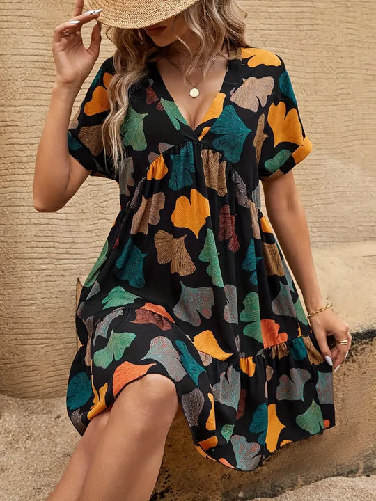 Heidi-Mode | Schwarzes Sommerkleid mit Blumenmuster V-Ausschnitt und Fledermausärmeln