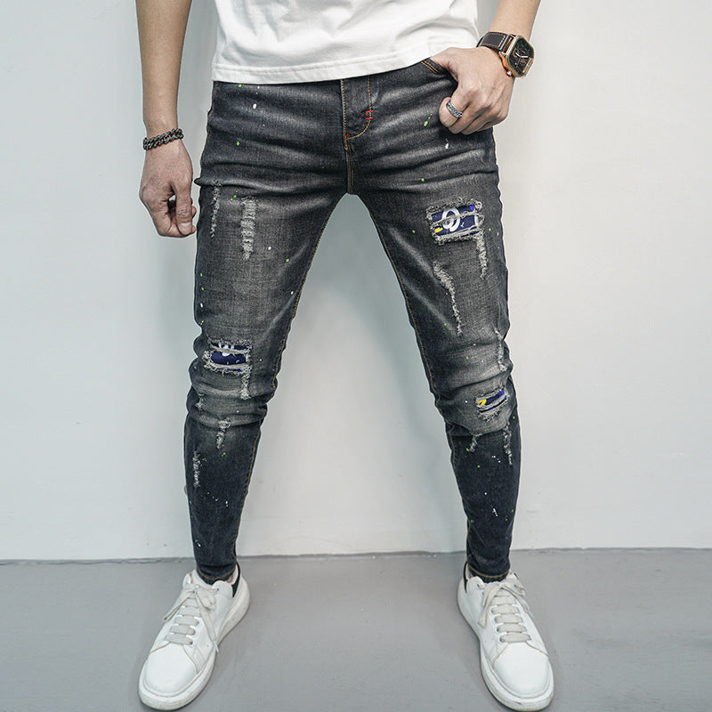 Herren Skinny Fit Jeans im kreativen Rissdesign und bunten Farbsklecks Heidi-Mode