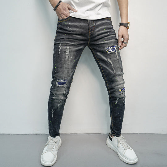 Herren Skinny Fit Jeans im kreativen Rissdesign und bunten Farbsklecks Heidi-Mode
