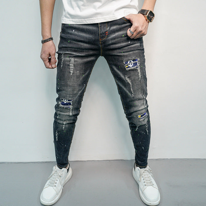 Herren Skinny Fit Jeans im kreativen Rissdesign und bunten Farbsklecks Heidi-Mode