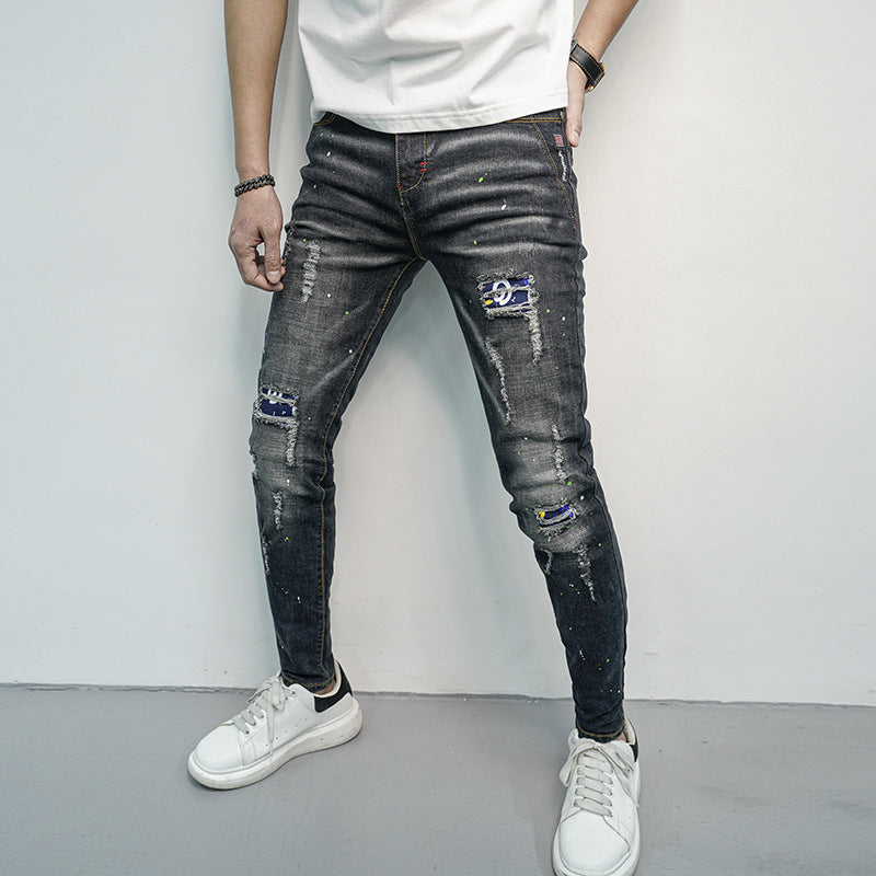 Herren Skinny Fit Jeans im kreativen Rissdesign und bunten Farbsklecks Heidi-Mode
