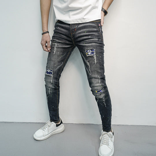 Herren Skinny Fit Jeans im kreativen Rissdesign und bunten Farbsklecks Heidi-Mode