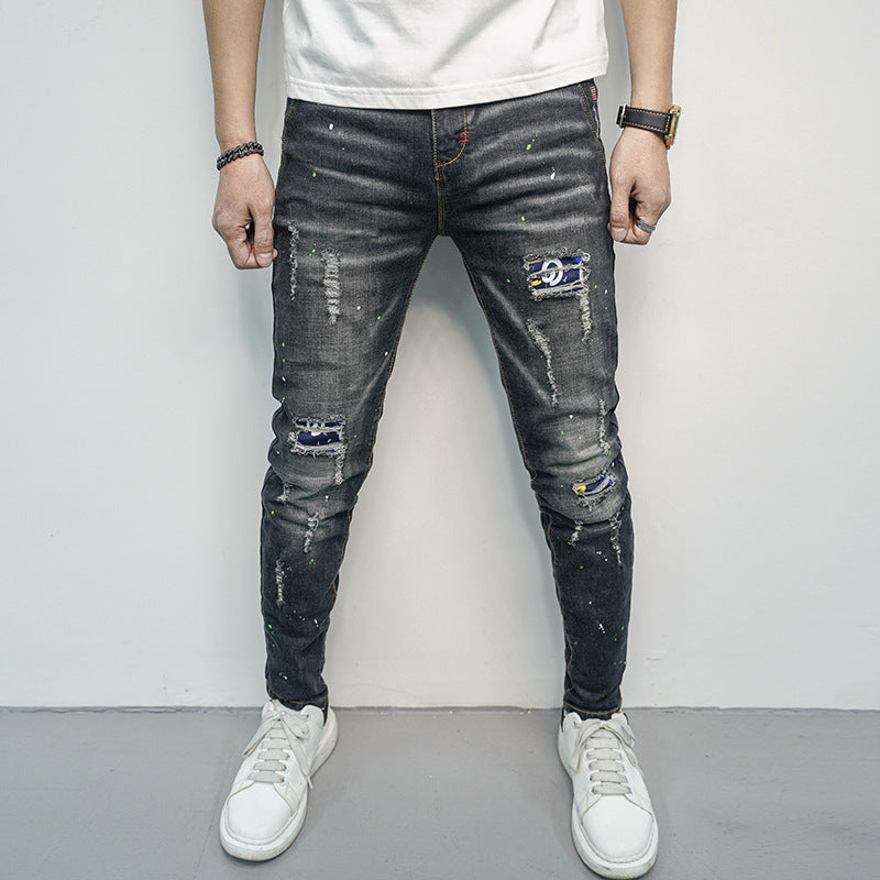 Herren Skinny Fit Jeans im kreativen Rissdesign und bunten Farbsklecks Heidi-Mode
