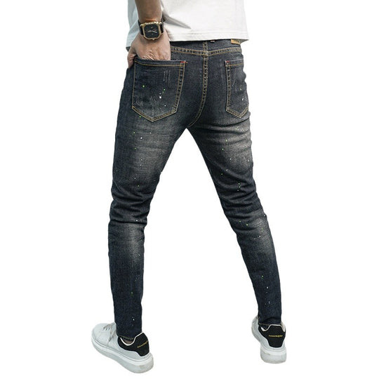 Herren Skinny Fit Jeans im kreativen Rissdesign und bunten Farbsklecks Heidi-Mode